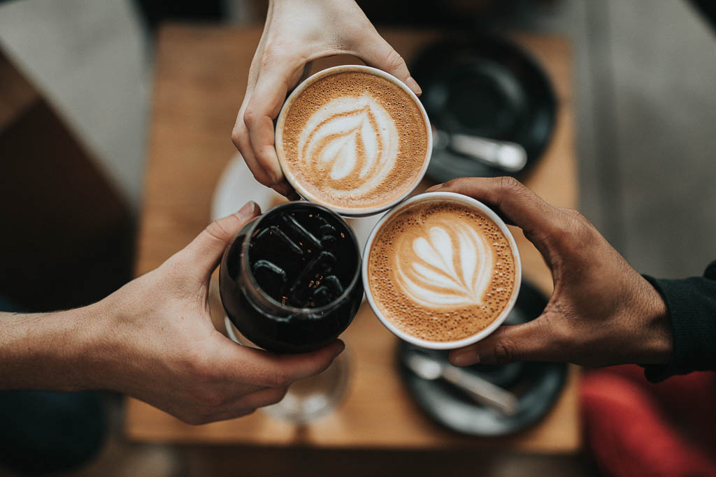 diverse hands holding coffee | support black-owned restaurants in NJ and NYC | foodwithaview.com